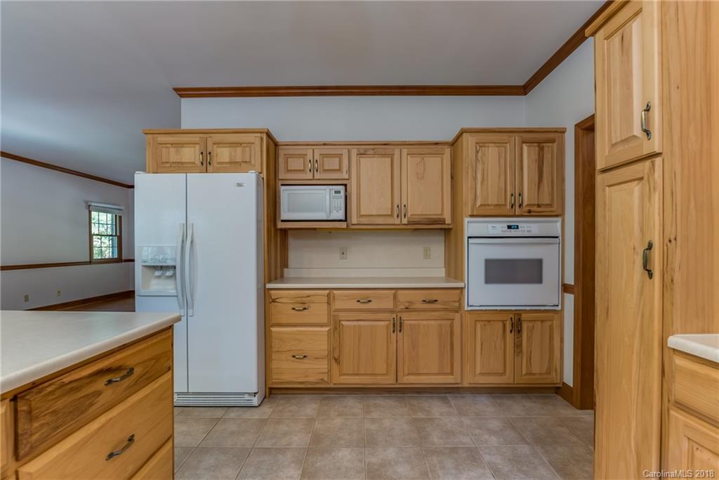 661 Henderson Road Tryon, NC 28782 - Photo 10 of 33 a kitchen with stainless steel appliances granite countertop a refrigerator and a stove top oven