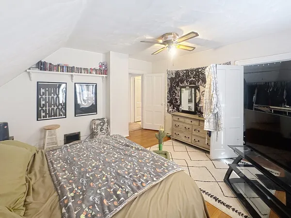 a bedroom with a bed and a flat screen tv