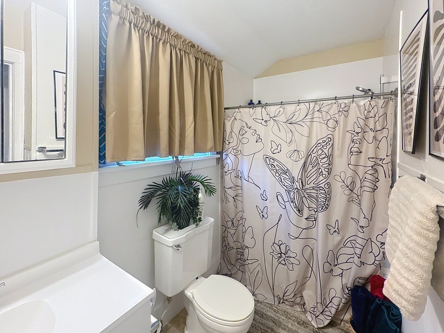 527 19th Avenue Moline, IL 61265 - Photo 13 of 22 a white toilet sitting next to a shower curtain