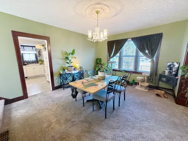 a dining room with furniture and a chandelier