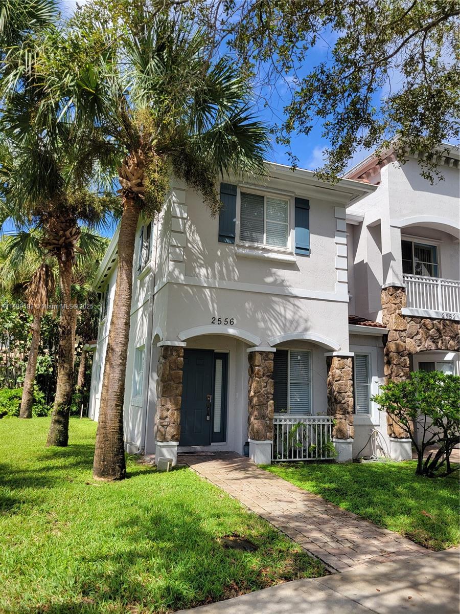 a front view of a house with a garden