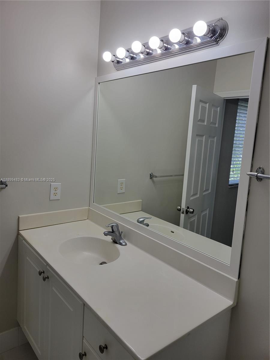2556 Southwest 83rd Avenue, Unit 101 Miramar, FL 33025 - Photo 12 of 19 a bathroom with a sink and a mirror