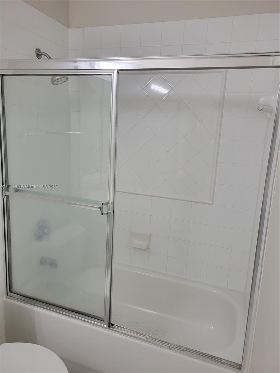 2556 Southwest 83rd Avenue, Unit 101 Miramar, FL 33025 - Photo 13 of 19 a bathroom with a shower and a glass door