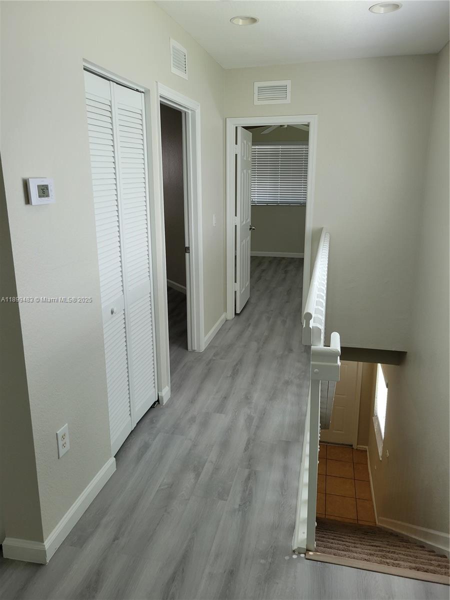 2556 Southwest 83rd Avenue, Unit 101 Miramar, FL 33025 - Photo 14 of 19 wooden floor in an empty room