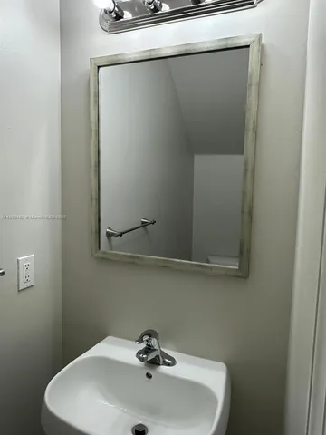 a bathroom with a sink and mirror