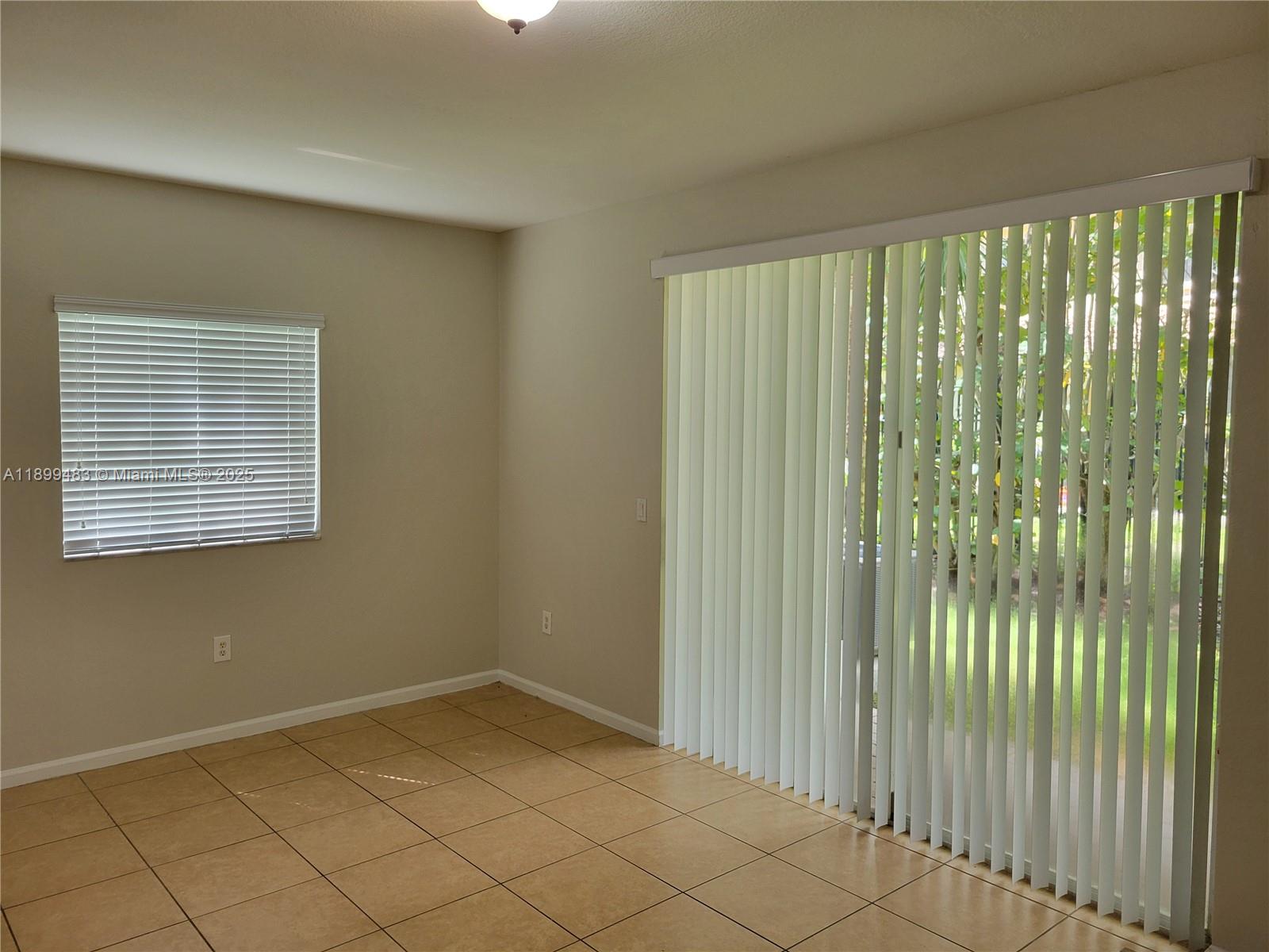 2556 Southwest 83rd Avenue, Unit 101 Miramar, FL 33025 - Photo 8 of 19 a view of an empty room and window