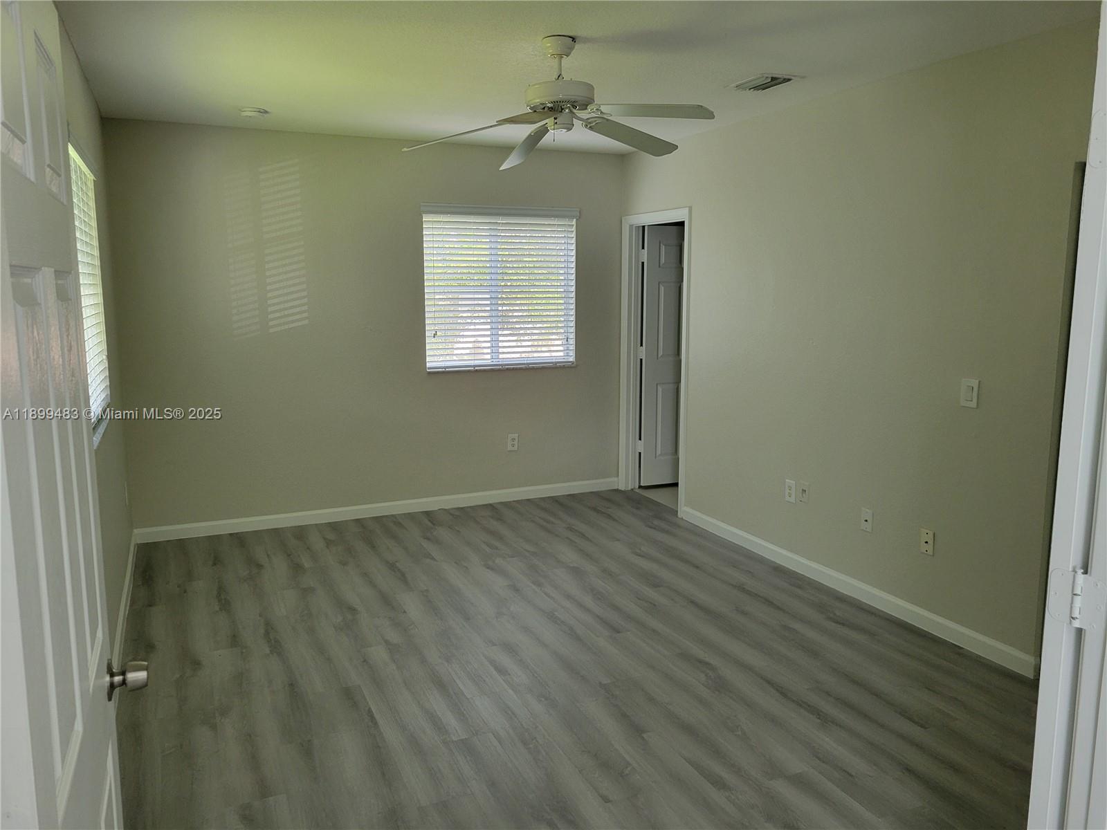 2556 Southwest 83rd Avenue, Unit 101 Miramar, FL 33025 - Photo 10 of 19 wooden floor in an empty room with a window