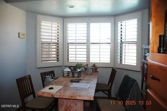 a view of a dining room with furniture and windows