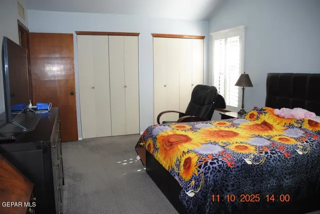 a bedroom with a bed and a flat tv screen