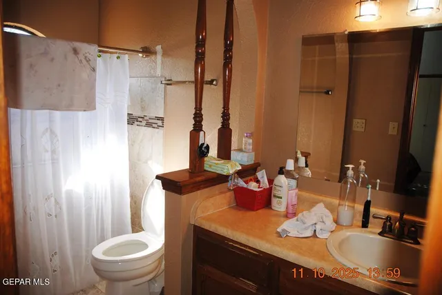 a bathroom with a granite countertop sink toilet and shower