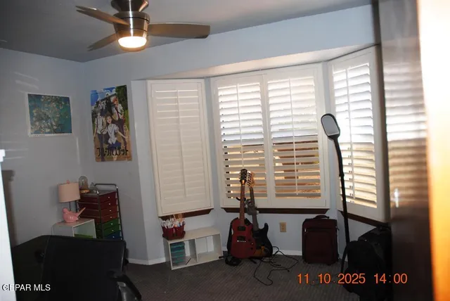 a view of a livingroom with workspace and a window