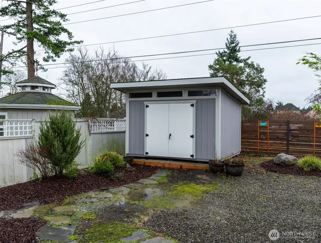 a view of a pathway of a house with backyard and trees