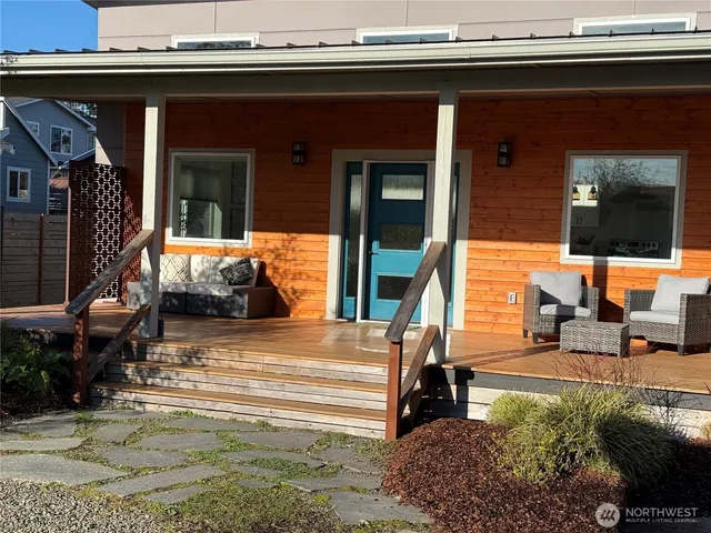 a kitchen with stainless steel appliances a dining table chairs stove refrigerator and cabinets