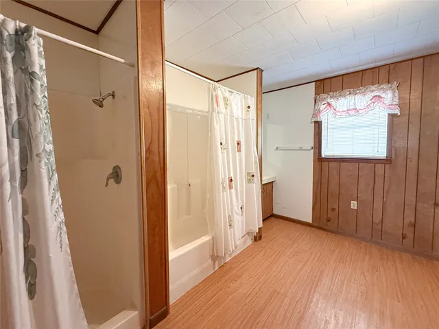 a view of a bathroom with a glass door shower and a mirror