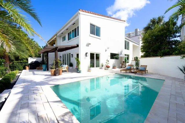 a view of a patio with swimming pool table and chairs