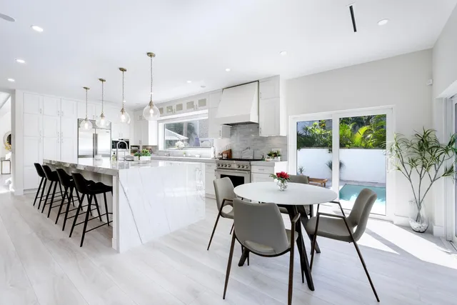 a bathroom with a granite countertop sink a toilet and a mirror
