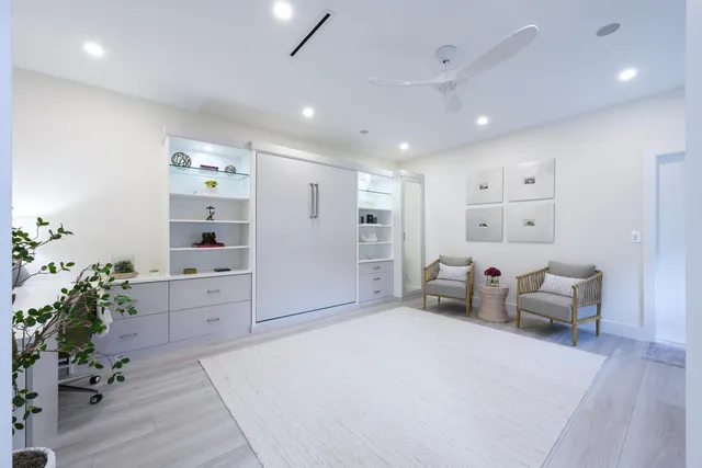 a living room with furniture and a potted plant