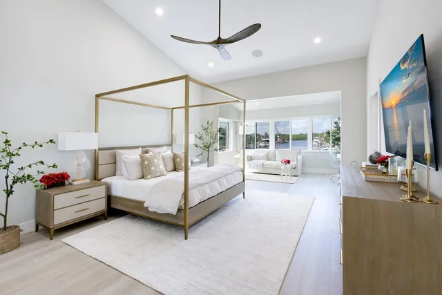 a spacious bathroom with a granite countertop sink a mirror and a bathtub