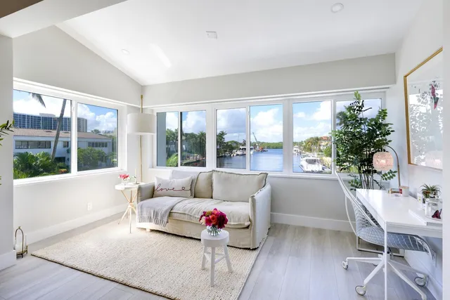 a bathroom with a tub a sink a mirror and a potted plant