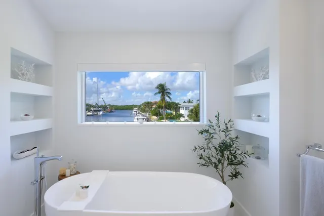 a hallway with wooden floor and windows