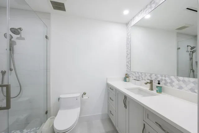 a bedroom with a large bed and a potted plant