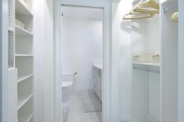 a bathroom with a sink toilet a mirror and shower