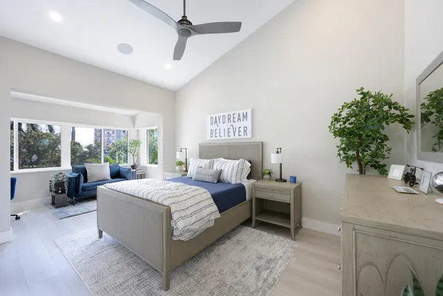 a view of a patio with couches and chairs next to a yard