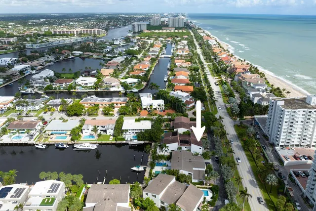 an aerial view of residential houses with outdoor space and river