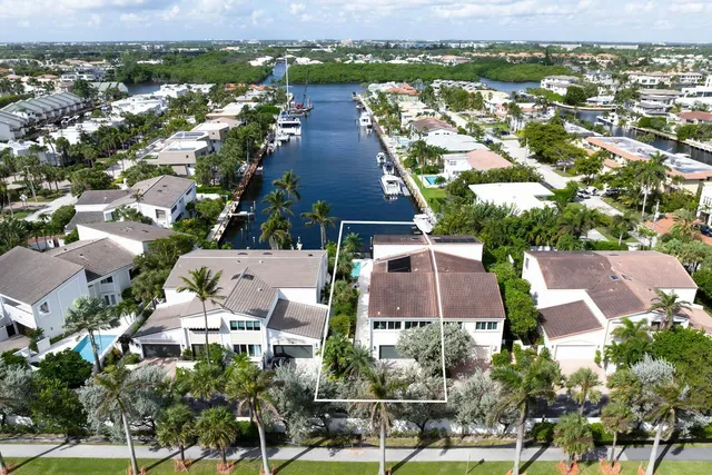 a view of a patio with table and chairs potted plants