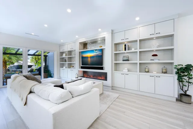 a kitchen with kitchen island a dining table and chairs