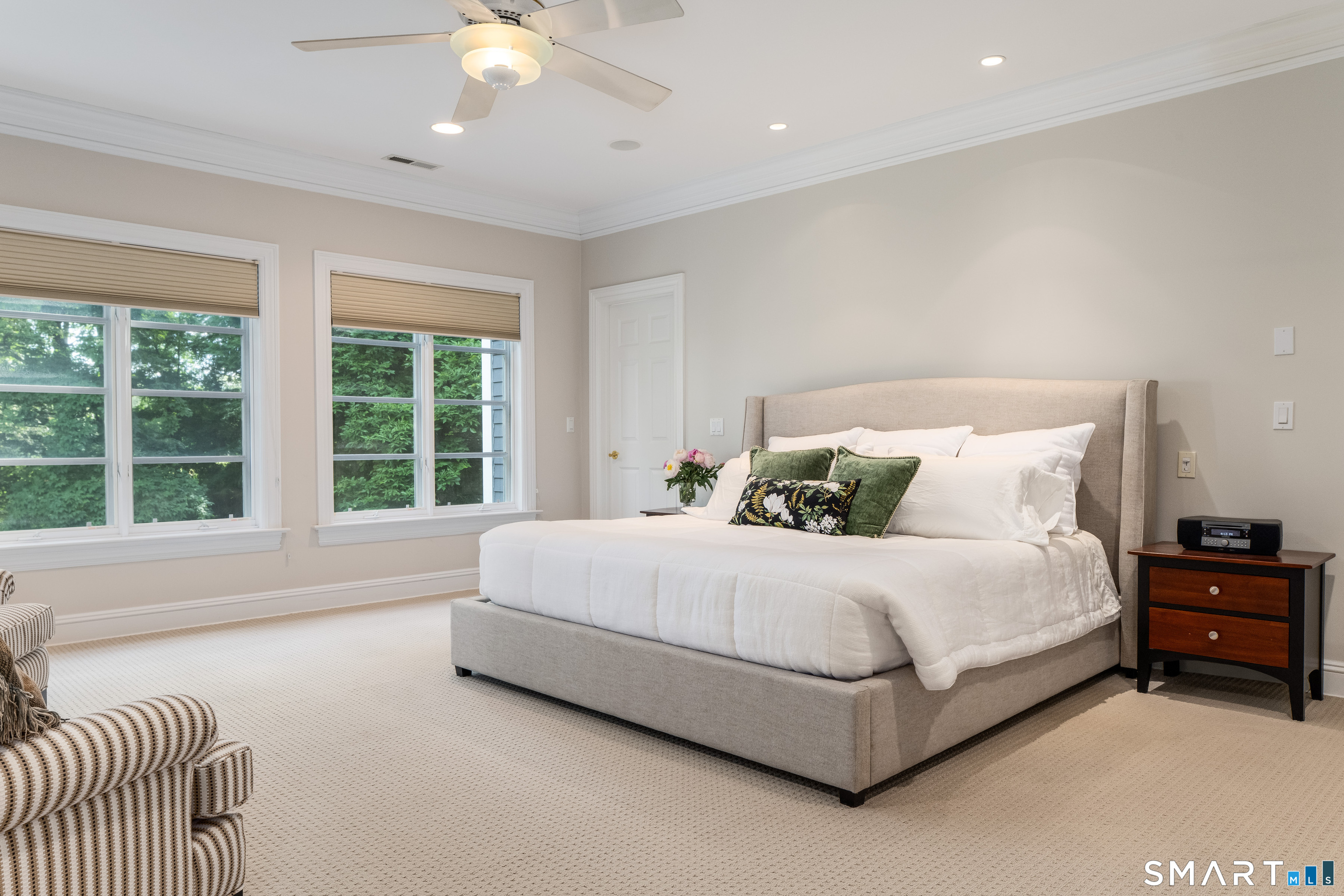 760 Smith Ridge Road New Canaan, CT 06840 - Photo 19 of 40 a spacious bedroom with a bed and a couch