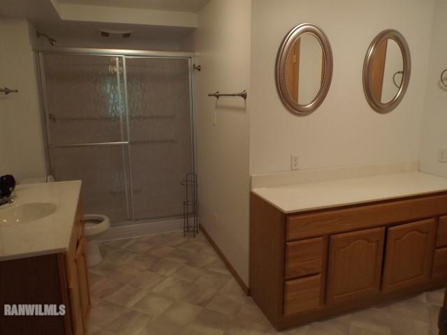 8796 East Center Road Stockton, IL 61085 - Photo 13 of 25 a bathroom with a granite countertop sink a toilet and a shower