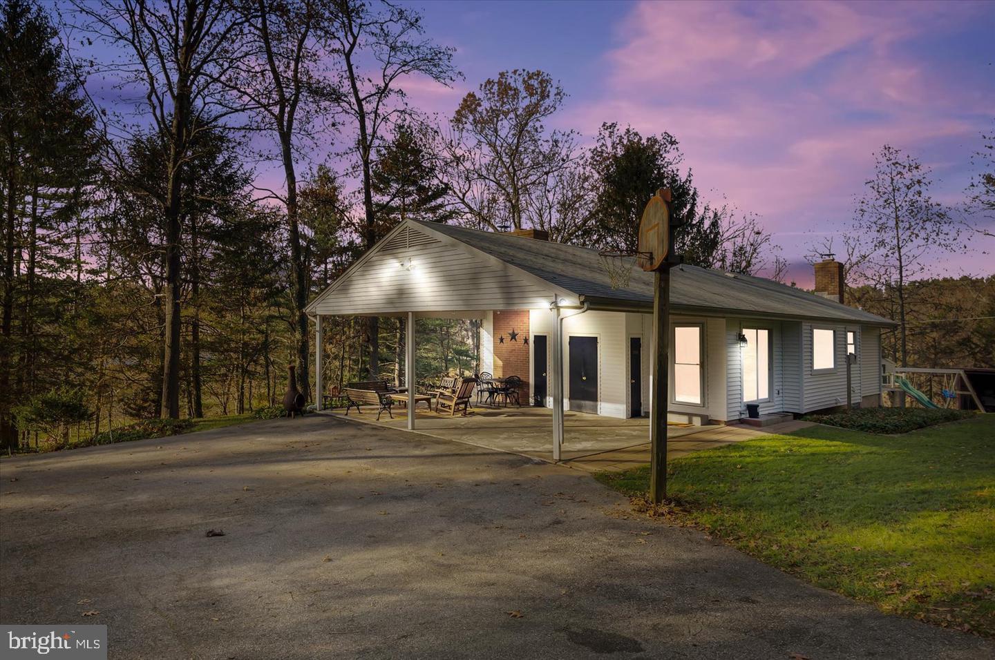 a front view of a house with a yard and trees