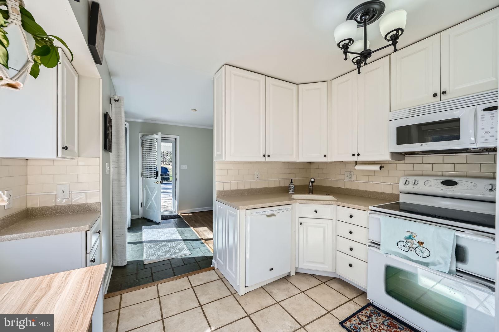 14629 Hanover Pike Upperco, MD 21155 - Photo 13 of 38 a kitchen with white cabinets sink and stainless steel appliances