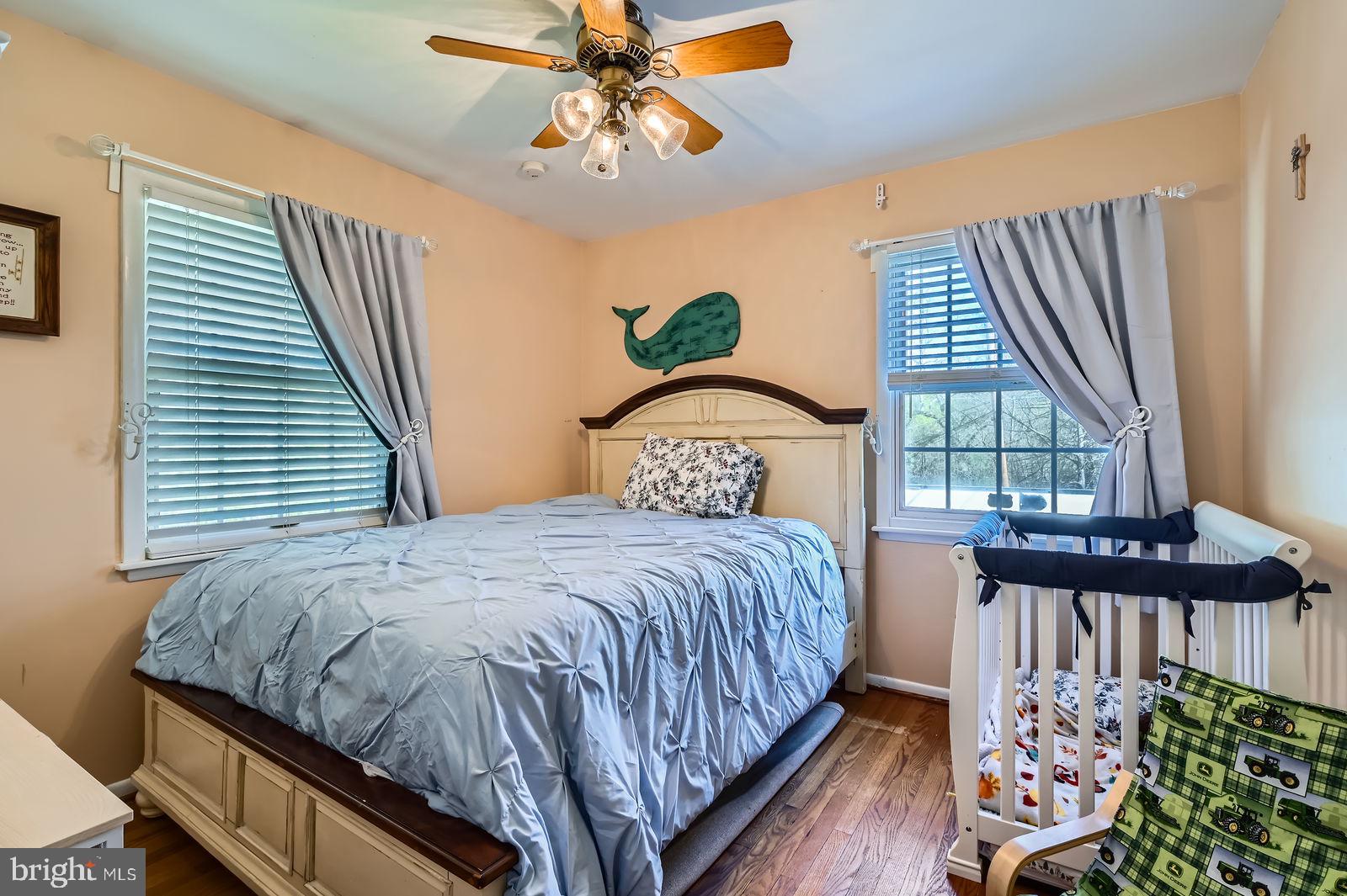 14629 Hanover Pike Upperco, MD 21155 - Photo 18 of 38 a bedroom with a bed a dresser and window