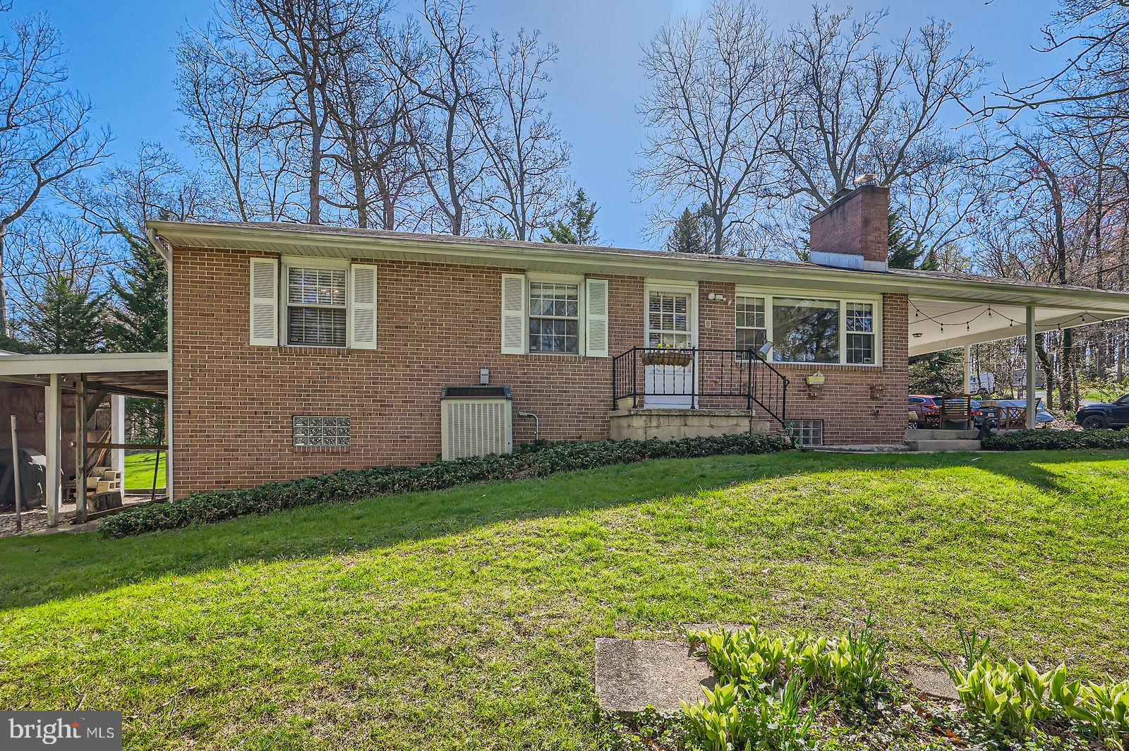 14629 Hanover Pike Upperco, MD 21155 - Photo 25 of 38 a front view of house with yard and trees in the background