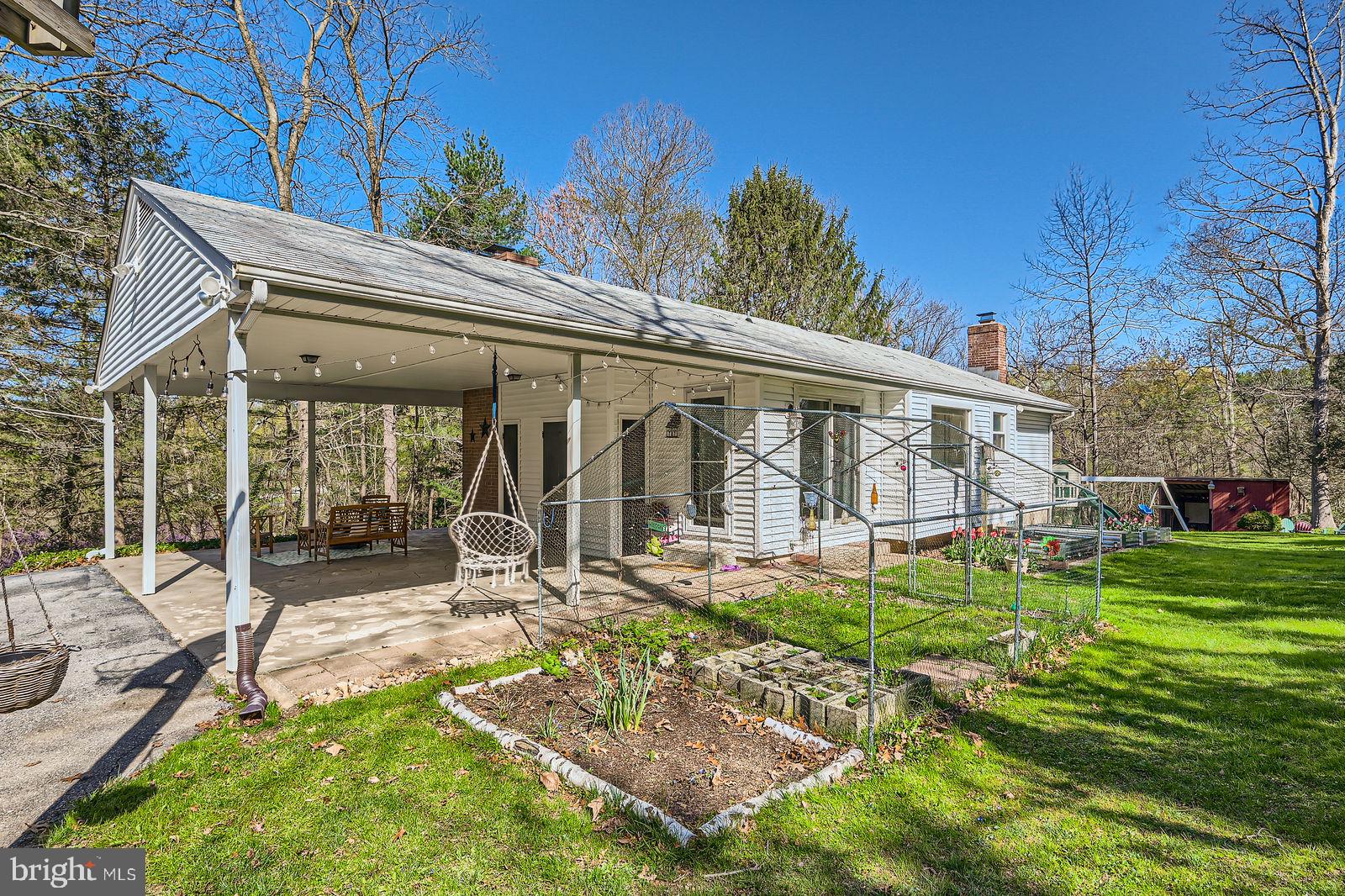 14629 Hanover Pike Upperco, MD 21155 - Photo 29 of 38 a view of a house with backyard sitting area and garden
