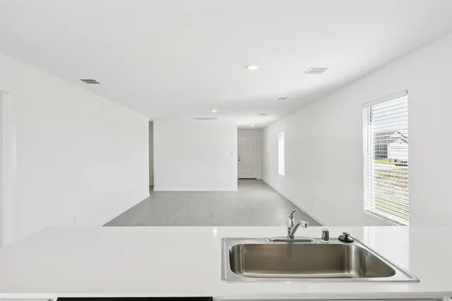 a kitchen with a sink and a mirror