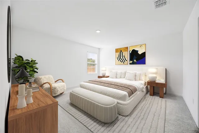 a bedroom with a bed and a potted plant