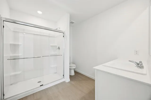 a bathroom with a shower and a sink