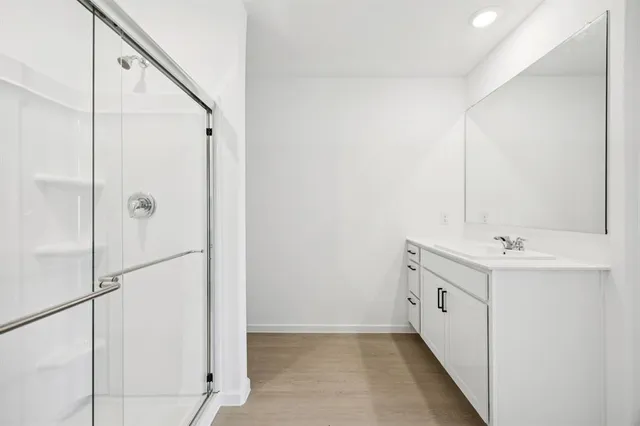 a bathroom with a double vanity sink and mirror