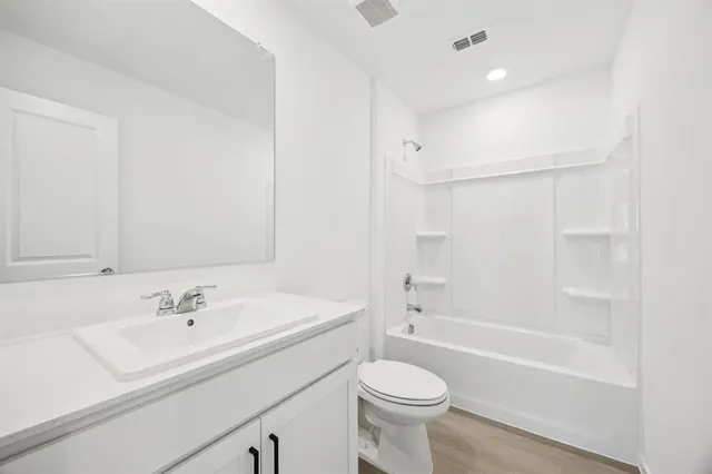 a bathroom with a sink a toilet and a bathtub