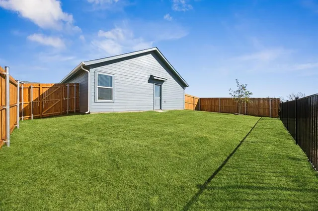 a backyard of a house with lots of green space