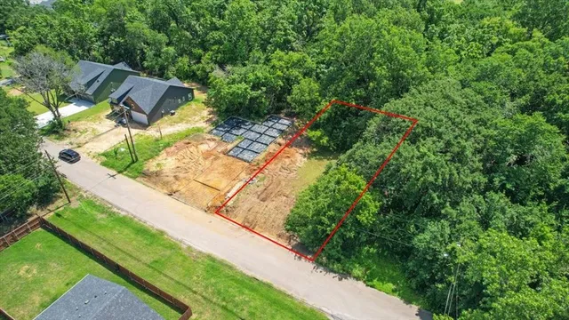 a view of a yard with potted plants