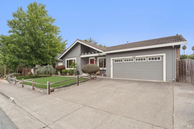 a view of backyard with a table and chairs and potted plants