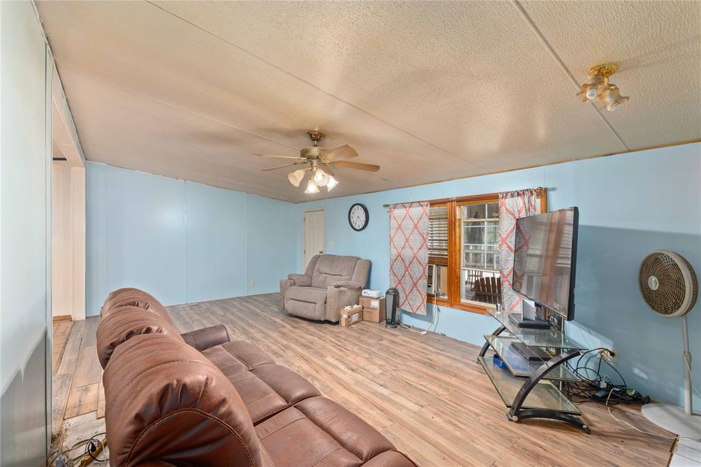210 7th Street Blanket, TX 76432 - Photo 7 of 33 a bedroom with a bed gym equipment and a large window