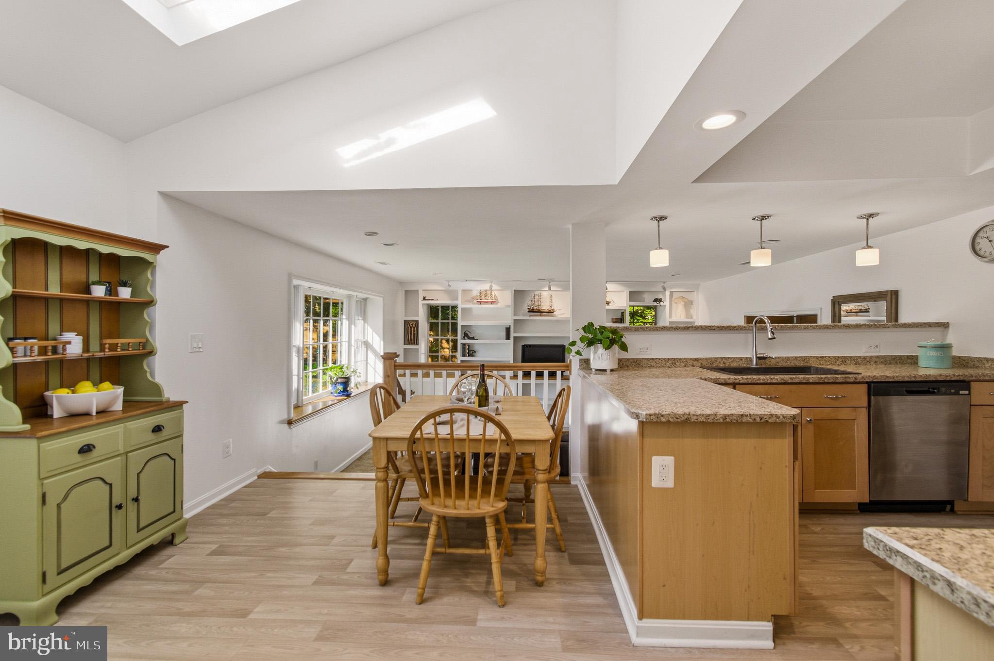 1016 Carrs Road Annapolis, MD 21403 - Photo 4 of 42 a kitchen with stainless steel appliances kitchen island granite countertop a table chairs in it and wooden floors
