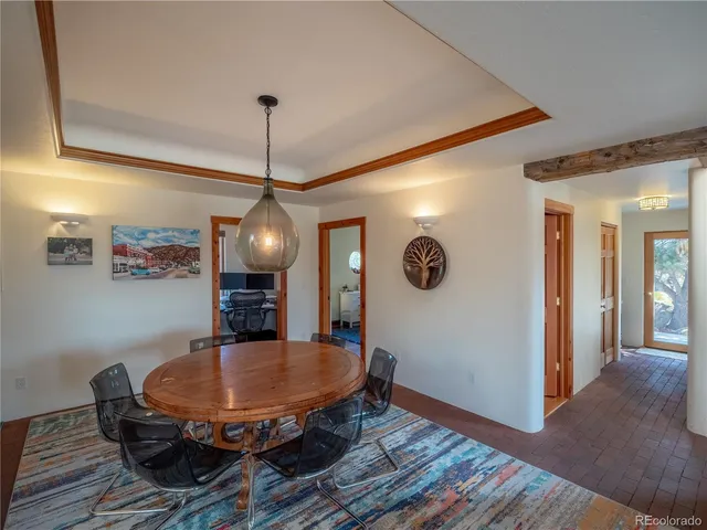 a dining room with furniture and wooden floor