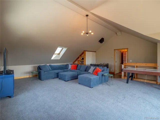 a living room with furniture and a pool table