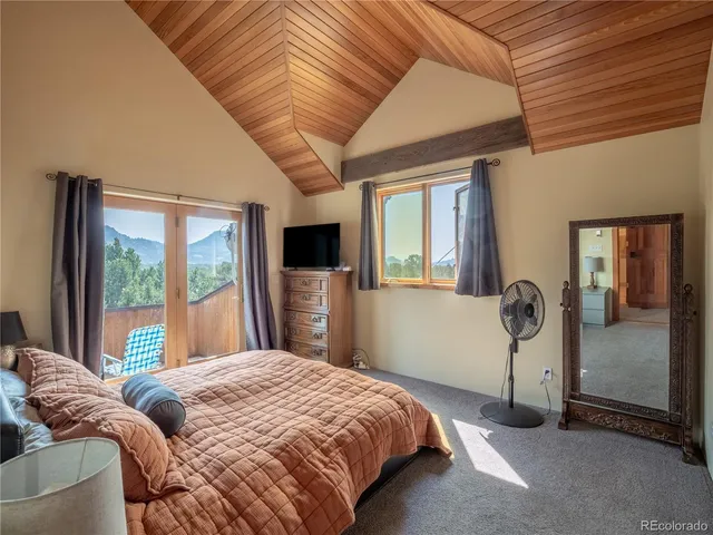 a bedroom with a bed and a large window